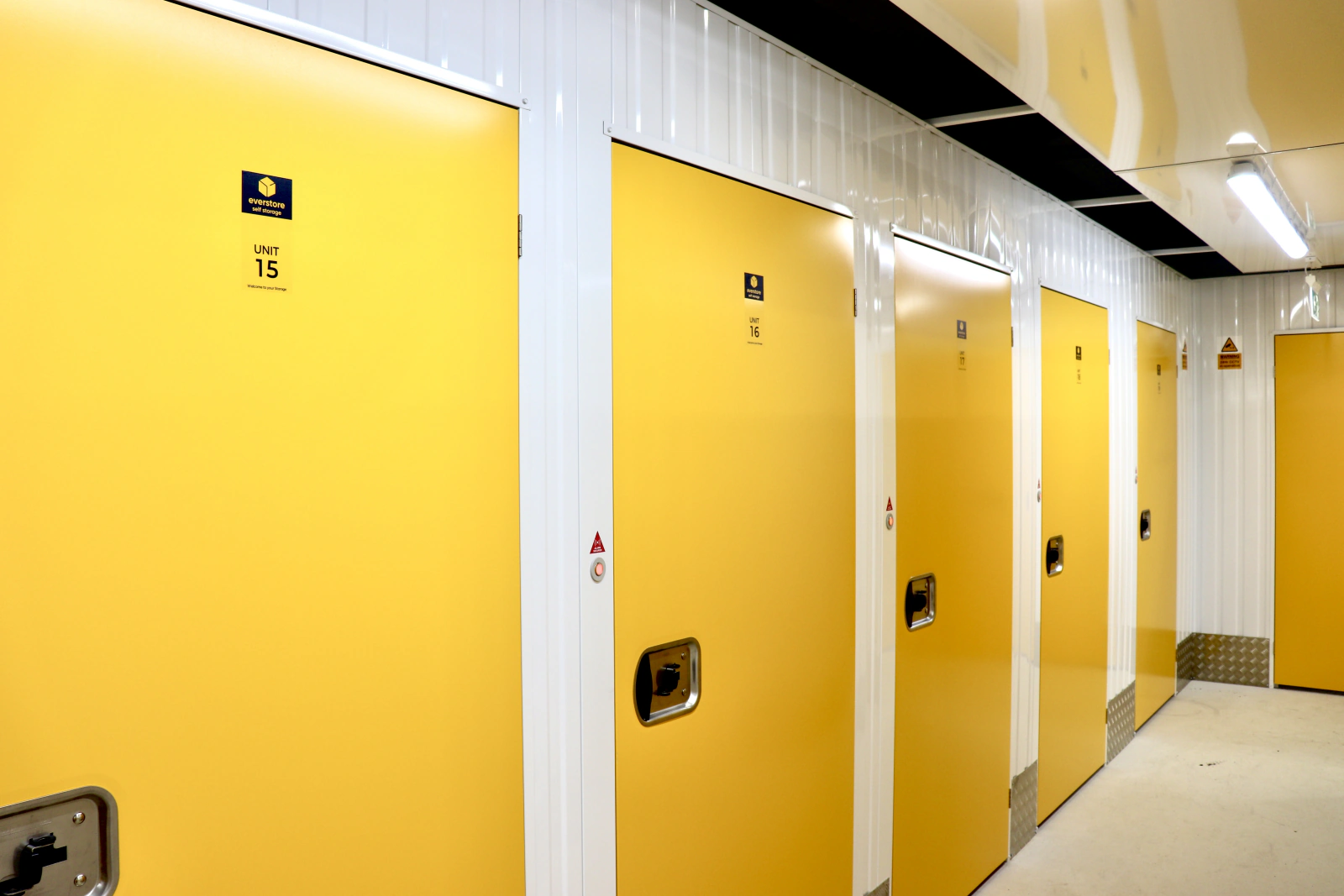 Close view of bright yellow storage unit doors inside the Everstore facility.