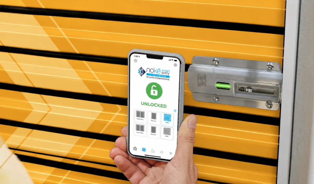A smartphone unlocking a storage unit through a keyless smart entry system.